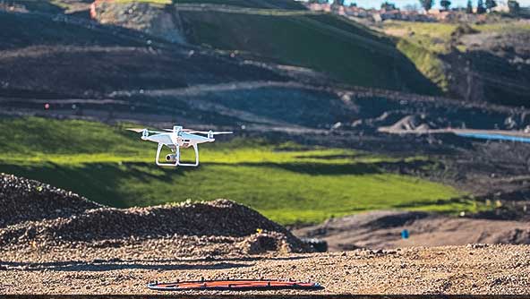 Image of a Hexagon autonomous drone hovering above the ground.